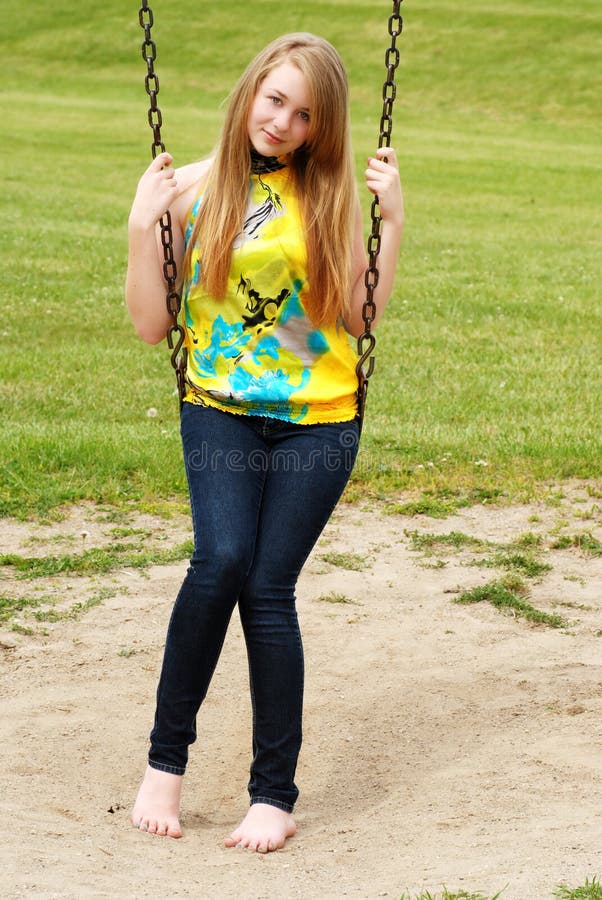 Young Teen Girl Sitting on a Swing Stock Image