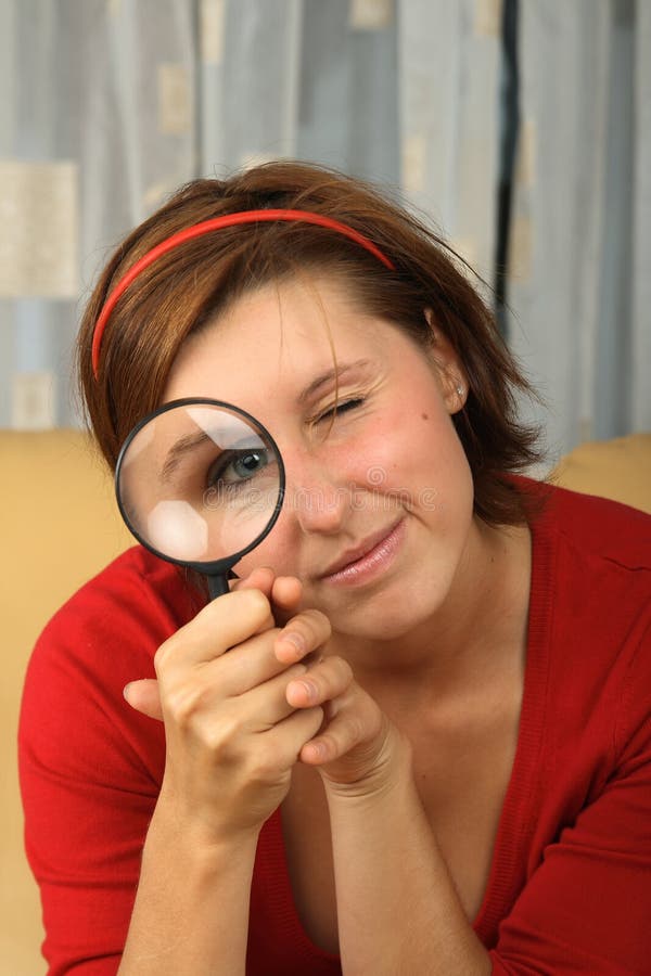 Young teenage holding a magnifying glass