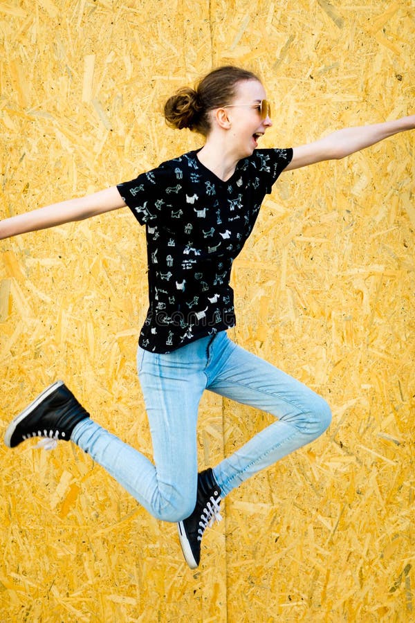 Young teenaged girl jumping in front of fence stock images Young teenaged girl jumping in front of fence stock images