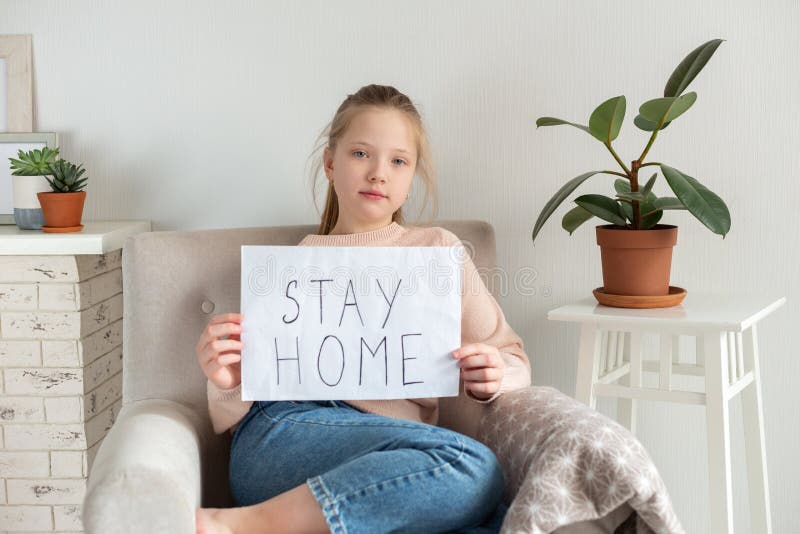 Young Teenager Girl With Sign Saying STAY HOME Self Isolation Concept