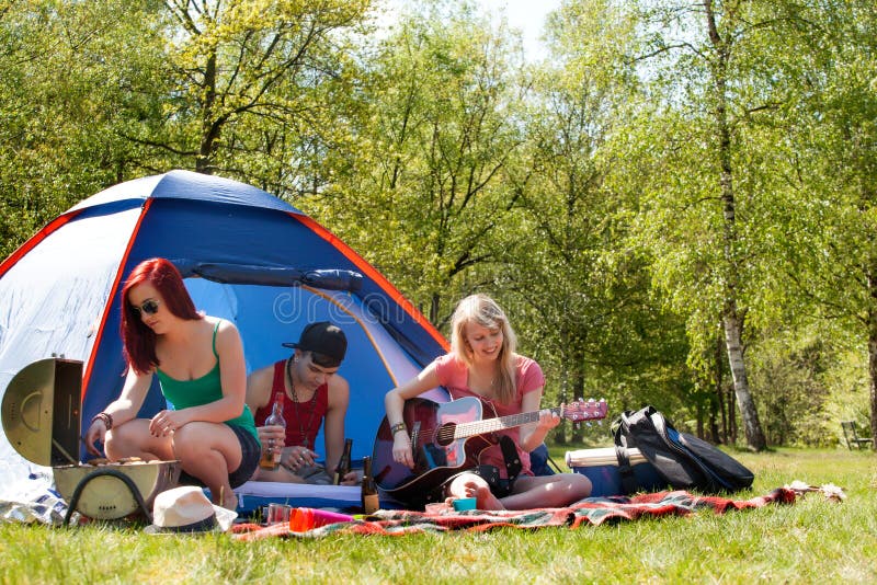 Young teenagers having a nice time on the camping