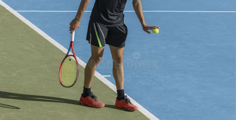 Young tennis player playing tennis on blue hard court. Male athlete with ball and racket is ready to serve at start of game. Sports background, copy space. Young tennis player playing tennis on blue hard court. Male athlete with ball and racket is ready to serve at start of game. Sports background, copy space