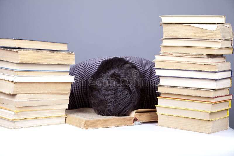 The young tired student with the books isolated.