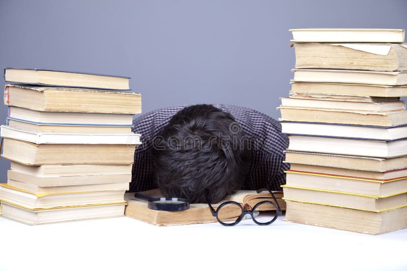 The young tired student with the books isolated.