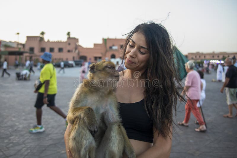 Trainer with monkey on a chain in Place Djemaa el Fna square marketplace in  Marrakech Morocco Stock Photo - Alamy