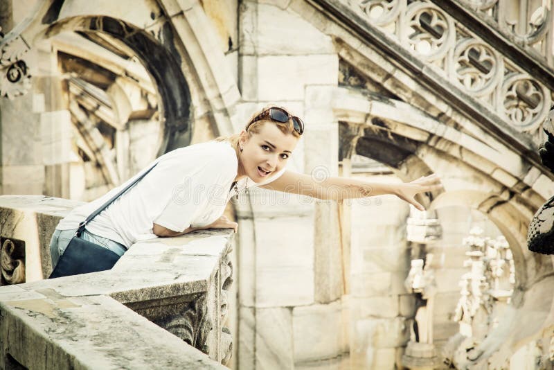 Young tourist woman on the Milan cathedral, Italy royalty free stock photography Young tourist woman on the Milan cathedral, Italy royalty free stock photography