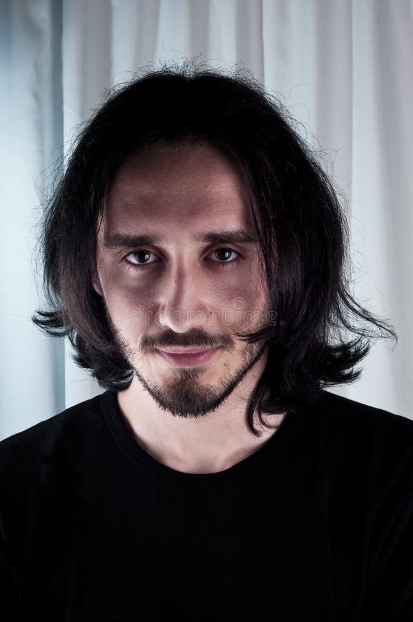 Portrait of a Young Man with Long Hair and Beard – Studio Photography stock images