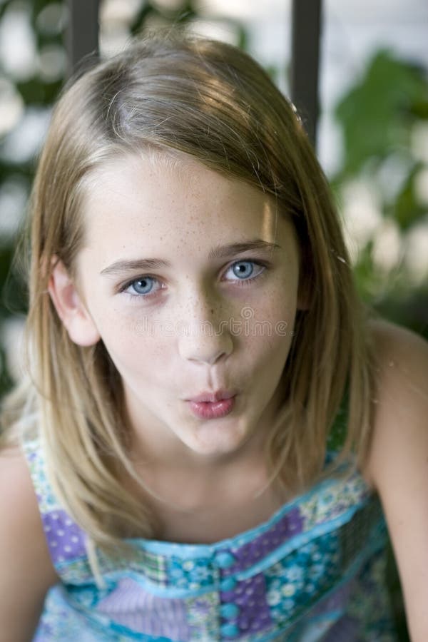 A young, attractive tween girl whistling. A young, attractive tween girl whistling.