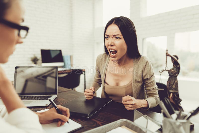 Young Upset Woman in Office with Lawyer in Glasses. Frustrated Woman. Problem in Relationship between People. Modern Law Office. Angry Young Woman. Marriage Problem. Young Advocate.