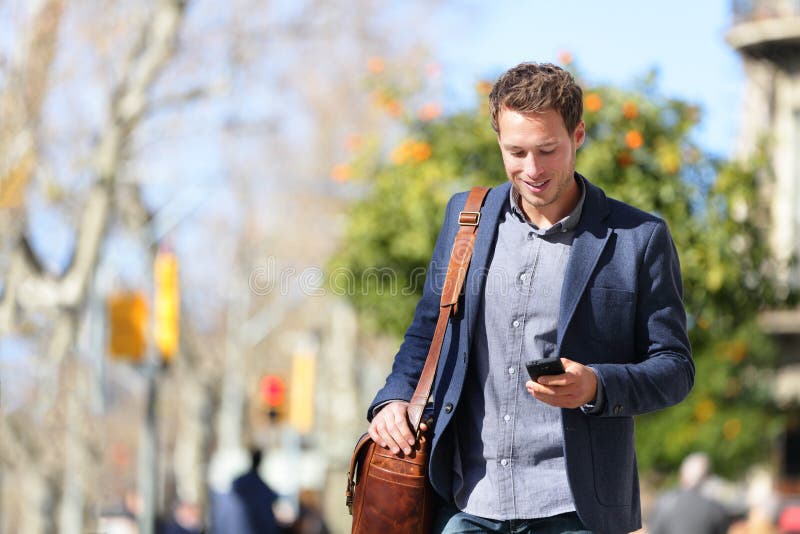 Young urban professional man using smartphone app
