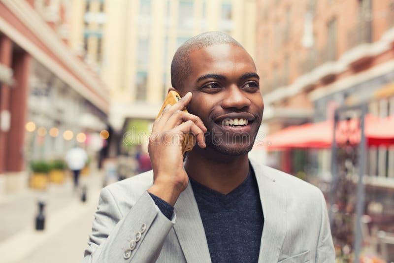 Portrait young urban professional smiling man using smart phone