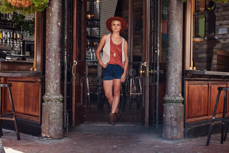 Young urban woman leaving a cafe