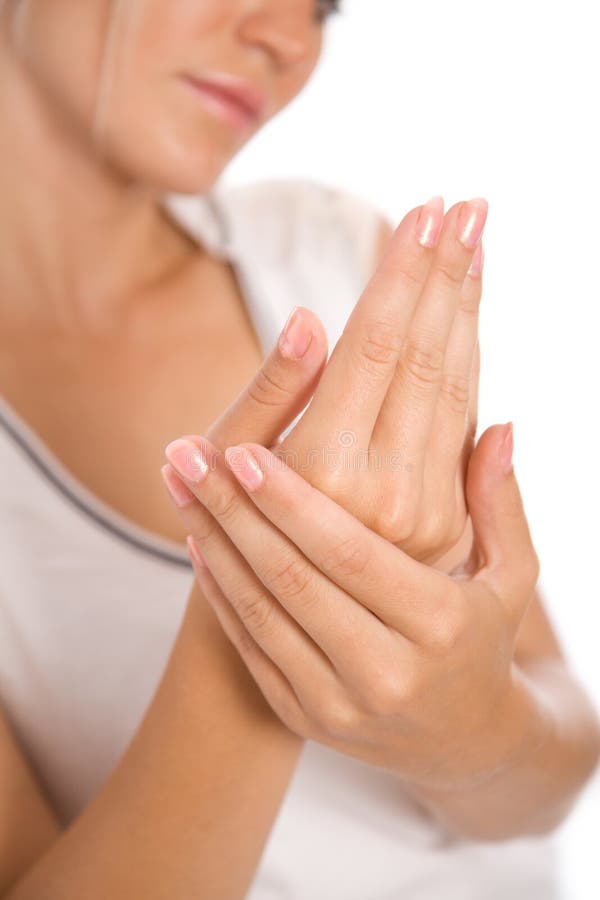 Young woman applying cream to hands