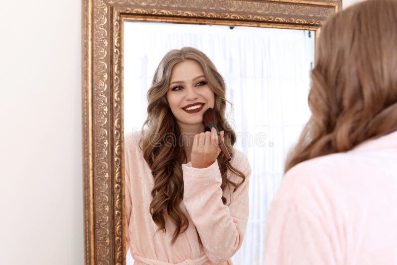 Young Woman Applying Makeup Near Mirror Stock Photo ...