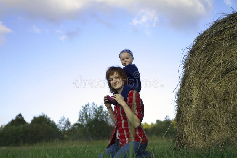 Young Woman with Baby Girl on Shoulders royalty free stock photo Young Woman with Baby Girl on Shoulders royalty free stock photo