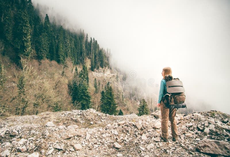 Young Woman with backpack relaxing outdoor. With foggy forest on background Lifestyle Travel concept Summer vacations royalty free stock photography Young Woman with backpack relaxing outdoor. With foggy forest on background Lifestyle Travel concept Summer vacations royalty free stock photography