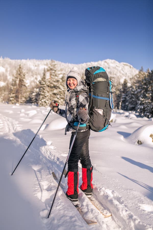 Young Woman with Backpack and Ski Goes To the Winter Mountains at Sunny ...