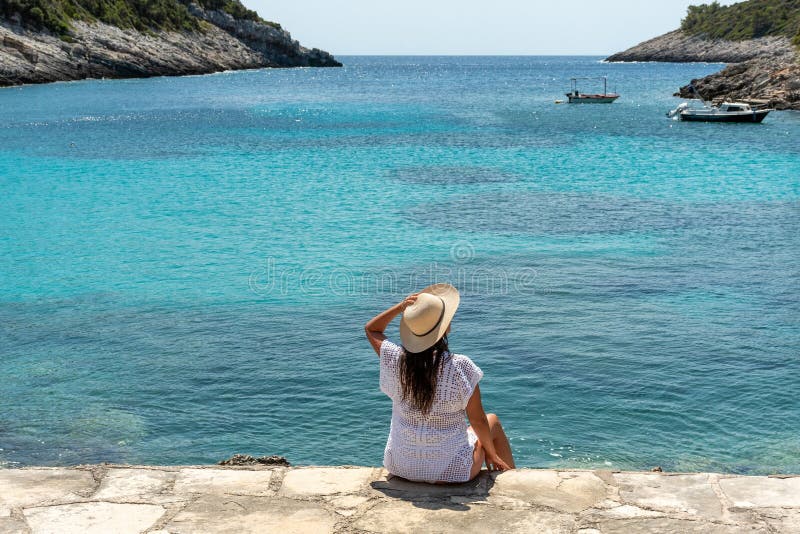 Young Woman in Beach Clothes Sitting on Shore Featuring Amazing ...