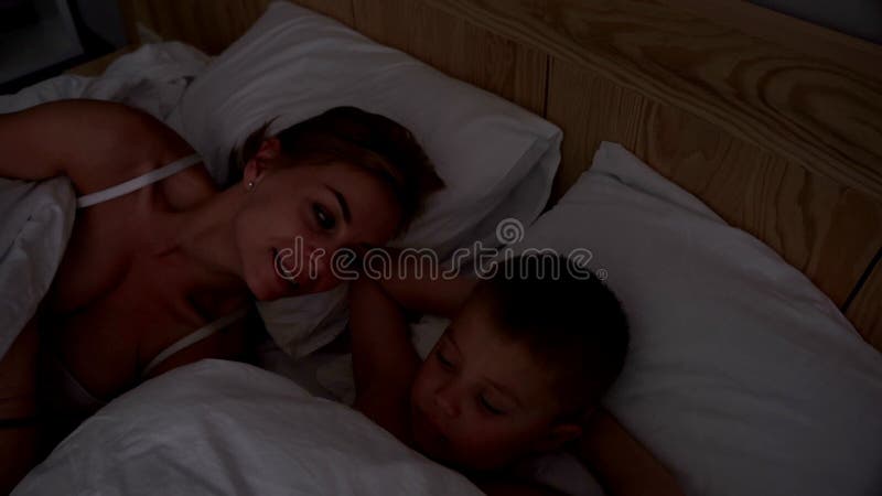 Young Woman in Bed with Her Young Son. Mom and Son Waking Up Together Stock Footage - Video of beauty, mother: 100467408