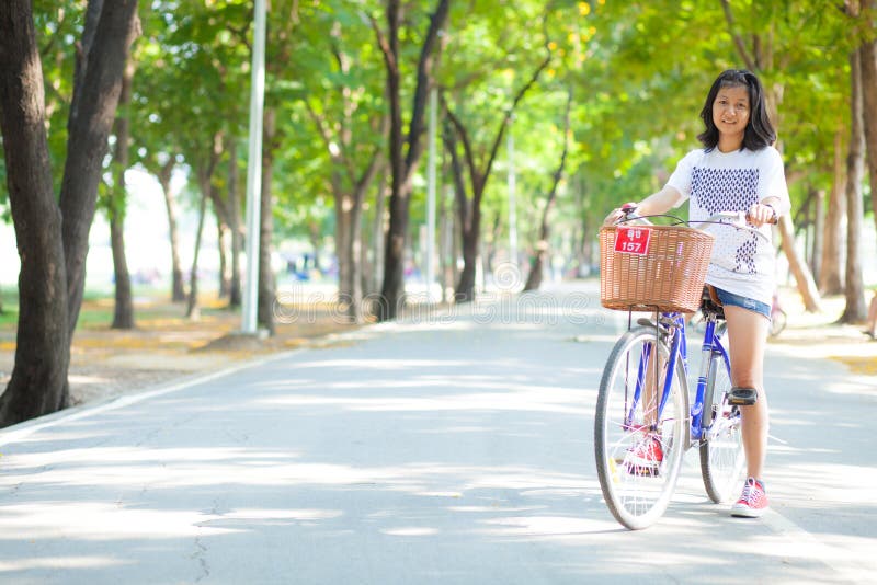 Young woman bicycling.