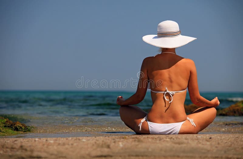 Young woman in bikini relaxing on beach