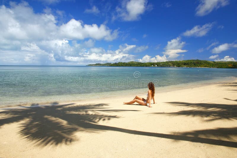 Young woman in bikini sitting on a tropical beach, Nananu-i-Ra i stock images Young woman in bikini sitting on a tropical beach, Nananu-i-Ra i stock images