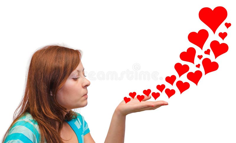 Young woman blowing hearts isolated on white background