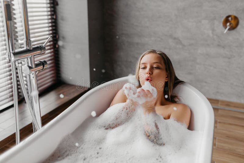 Young lass having fun in the bath