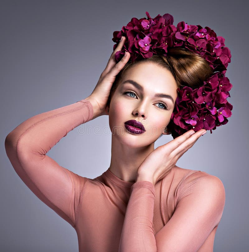 Young Woman with a Bouquet of Purple Flowers in Her Hair. Stock Image ...