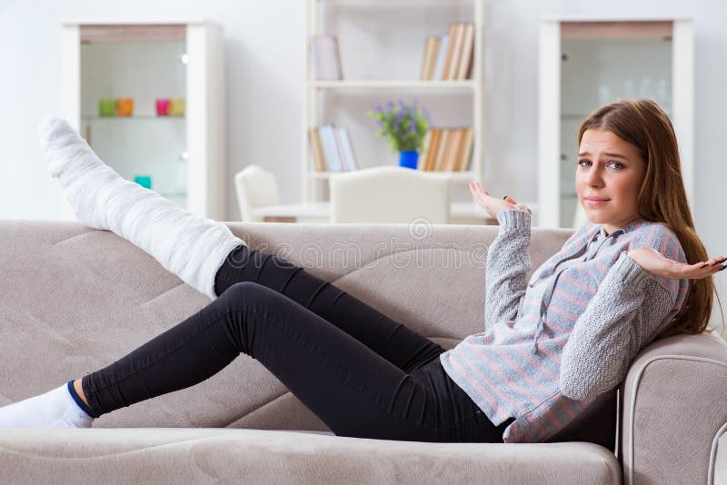 The young woman with broken leg at home