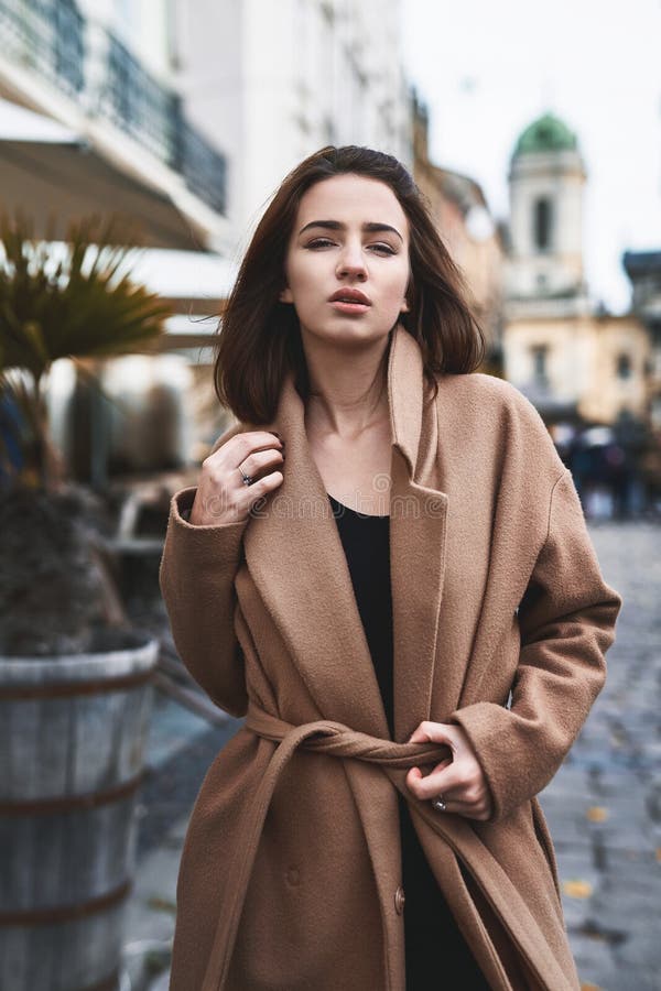 Young Woman in Brown Coat Posing on the Street Stock Photo - Image of ...