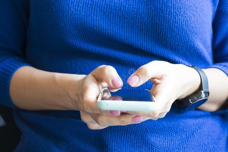 Young woman browsing smartphone at home or at the office royalty free stock image Young woman browsing smartphone at home or at the office royalty free stock image