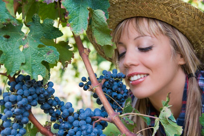 Young woman and bunch of grapes
