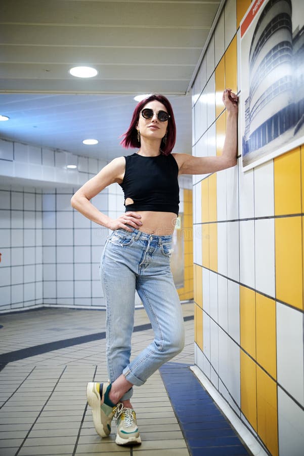 Young Woman with Burgundy Red Maroon Short Hair, Wearing Black Top and Light Blue Jeans, Leaning on the Wall in Subway Station, Stock Photo - Image of metro, beautiful: 180528158 Young Woman with Burgundy Red Maroon Short Hair, Wearing Black Top and Light Blue Jeans, Leaning on the Wall in Subway Station, Stock Photo - Image of metro, beautiful: 180528158