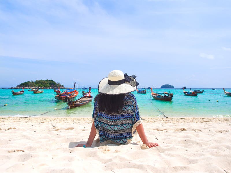 Young woman chilling on the beach and looking to the sea. stock images Young woman chilling on the beach and looking to the sea. stock images
