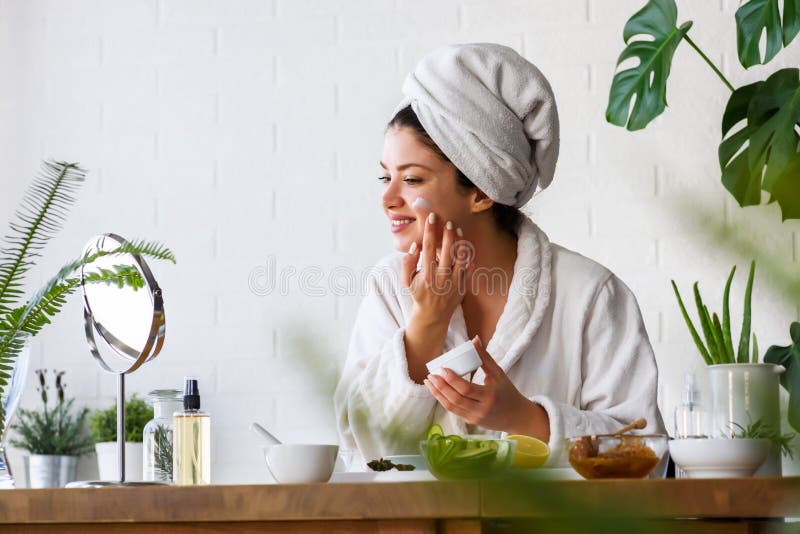 Young woman cleaning face with natural cosmetics. Clean fresh skin care.