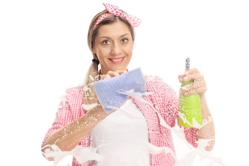 Young woman cleaning a window with towel and detergent stock images Young woman cleaning a window with towel and detergent stock images