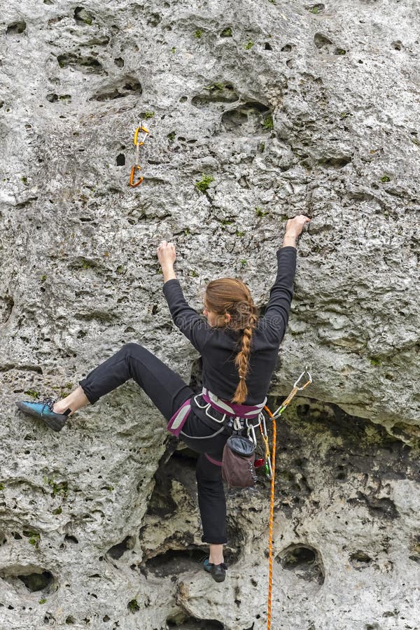 Young woman climbing rock. stock image. Image of female 41049877