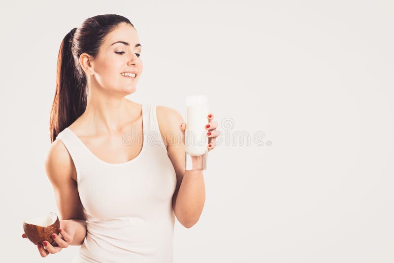 Young woman with coconut and coconut milk royalty free stock photo