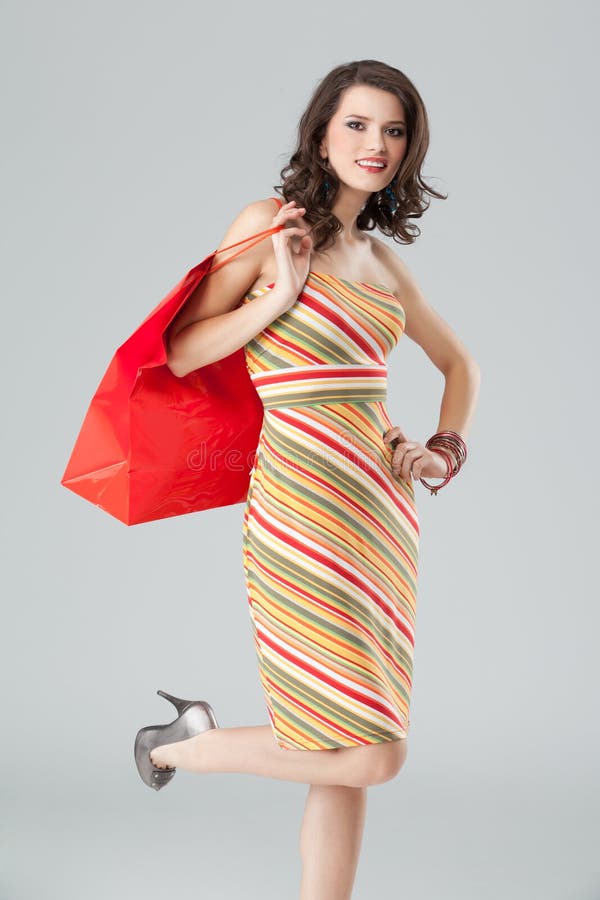 Young woman in colourful outfit, holding a bag stock images Young woman in colourful outfit, holding a bag stock images