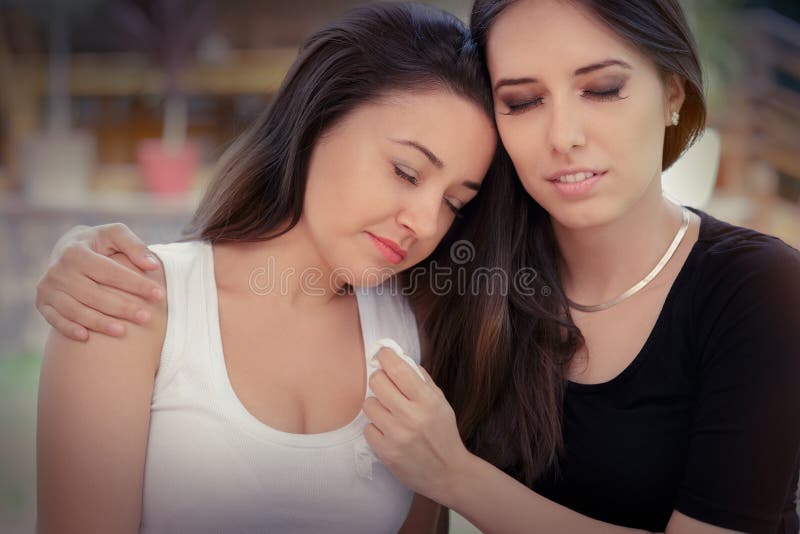 Portrait of Two women console each other in painful situation. Portrait of Two women console each other in painful situation