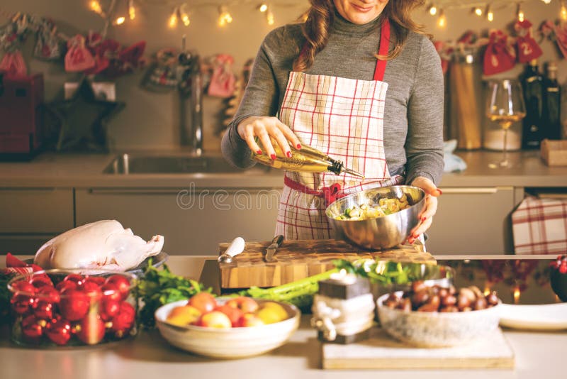 Young Woman Cooking in the kitchen. Healthy Food for Christmas stuffed duck or Goose