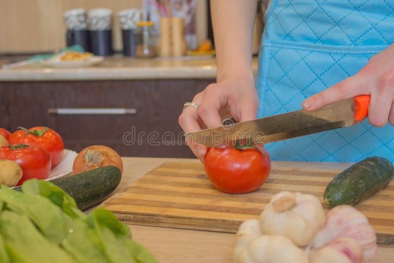Young Woman Cooking in the Kitchen. Cropped Image of Young Girl Cutting ...
