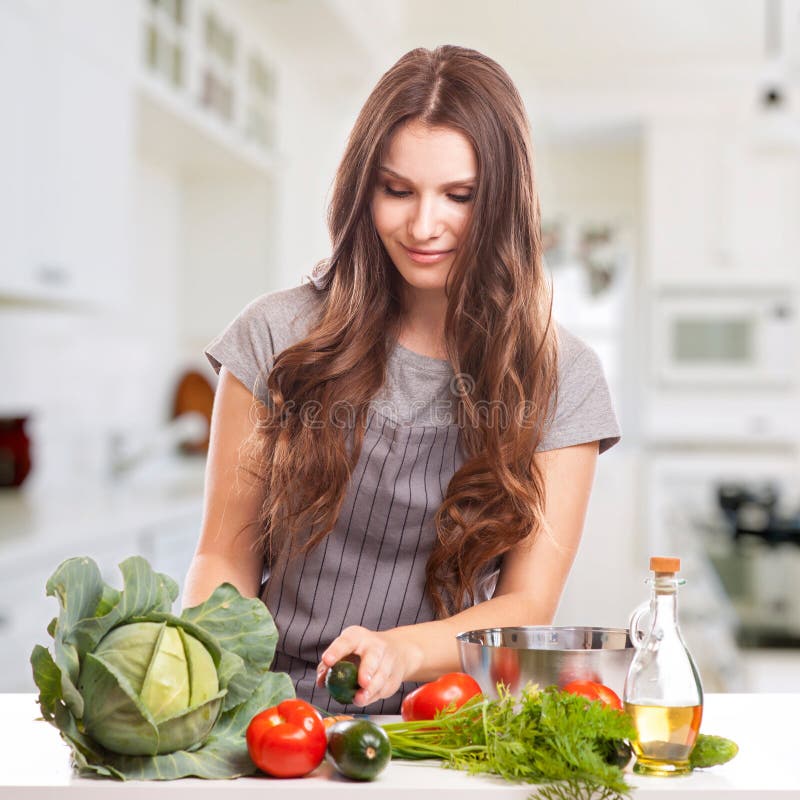 Young Woman Cooking in the kitchen. Healthy Food - royalty free stock images Young Woman Cooking in the kitchen. Healthy Food - royalty free stock images