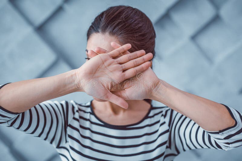 Young Woman Covering Her Face with Crossed Hands Stock Photo - Image of ...