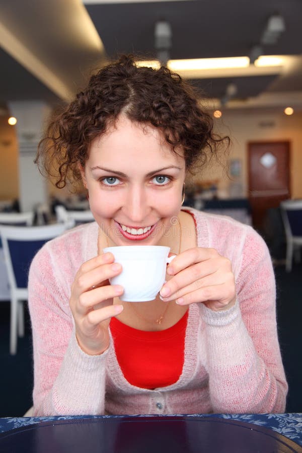 Young woman with cup in cafe