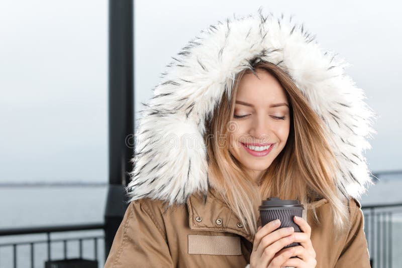 Young Woman with Cup of Coffee Walking Outdoors. Stock Photo Image of