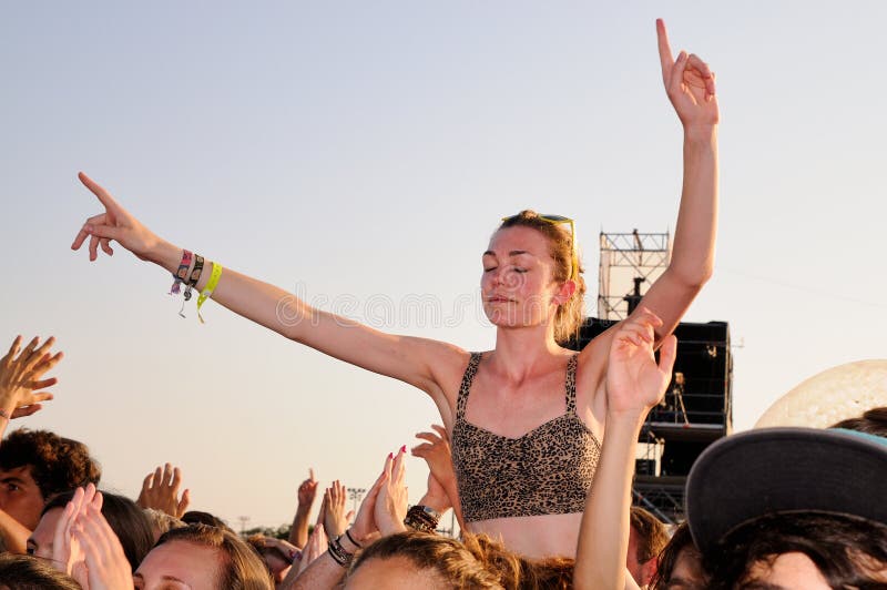 Young woman dances above the crowd in a concert at FIB (Festival Internacional de Benicassim) stock photos Young woman dances above the crowd in a concert at FIB (Festival Internacional de Benicassim) stock photos