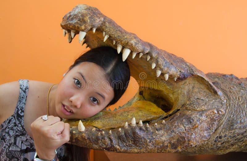 Young woman in danger with crocodile mouth