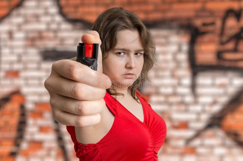 Young woman is defending with pepper spray. Self defense concept royalty free stock photo